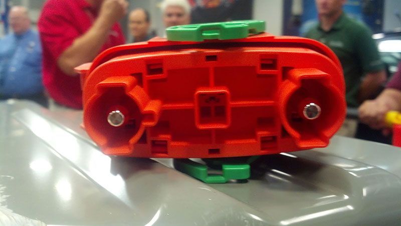 A close up of a red and green object on a table | Autotrends