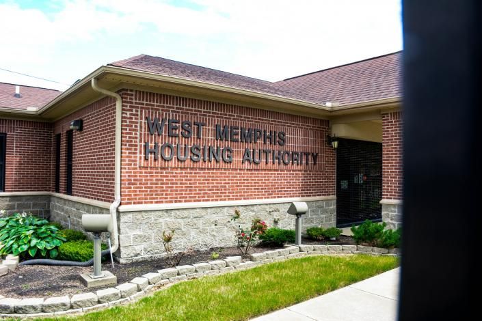 West Memphis Housing Authority brick building with sign and landscaped entrance