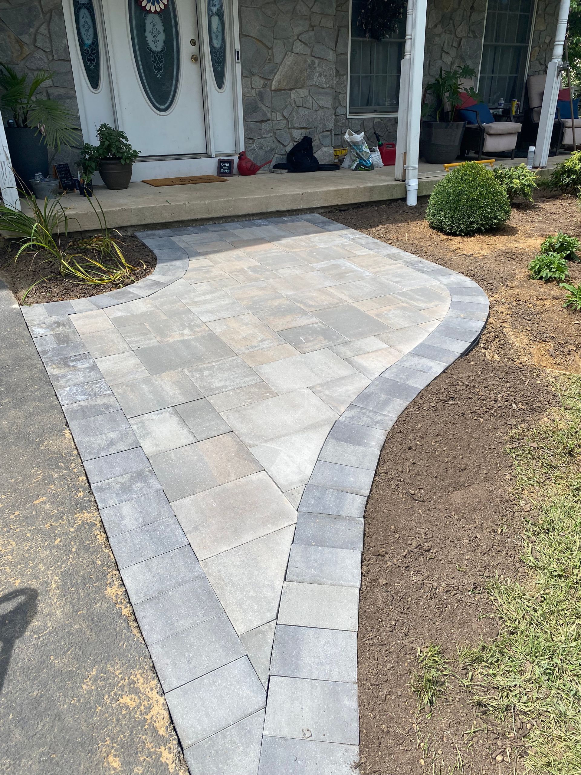 A brick walkway leading to the front door of a house.