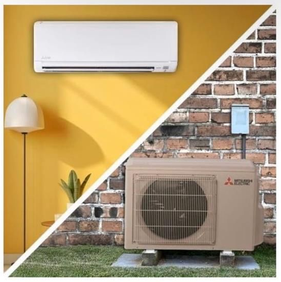 A person adjusts the settings on a white wall-mounted gas boiler by turning a dial on the control panel.