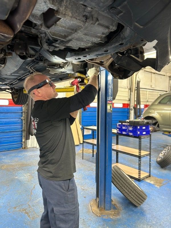 Technician Working Under Car