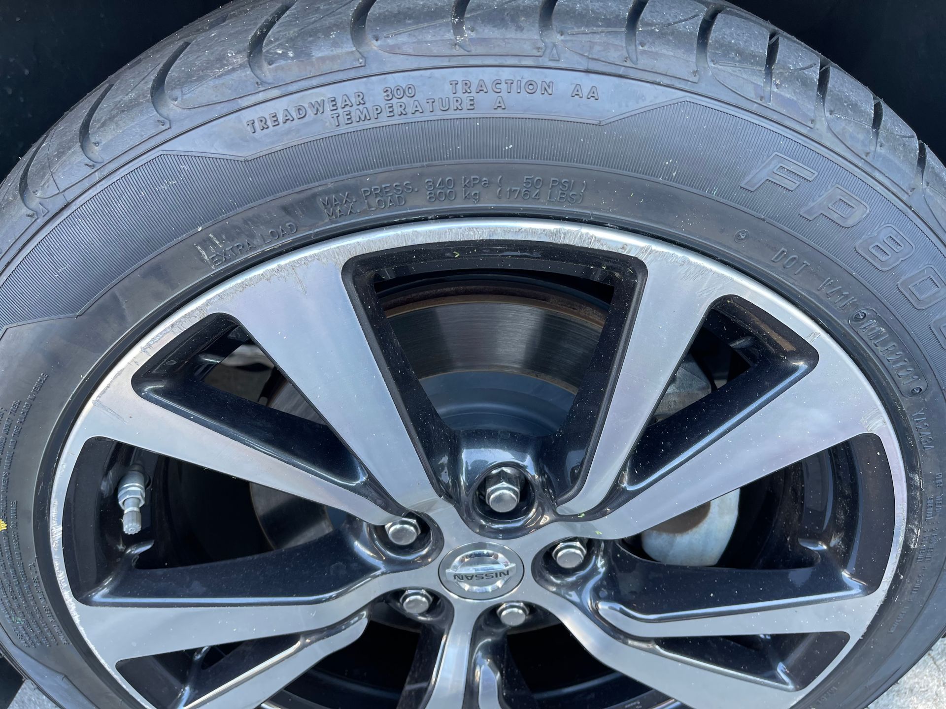 A close up of a tire on a car wheel.