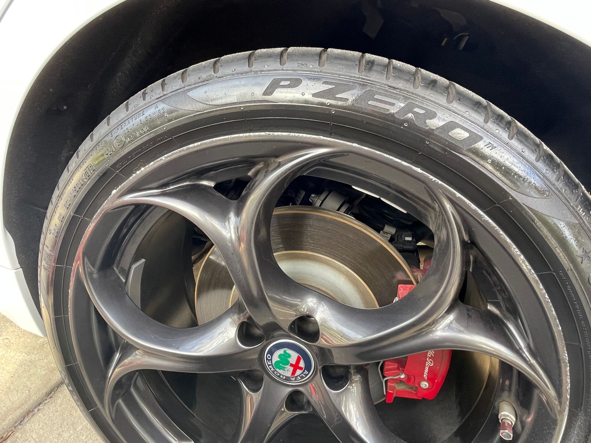 A close up of a tire on a white car