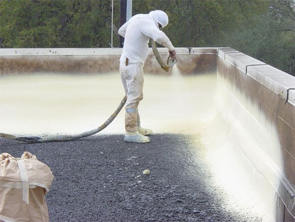 A person is pointing at a cone shaped roof with the sun shining through it.