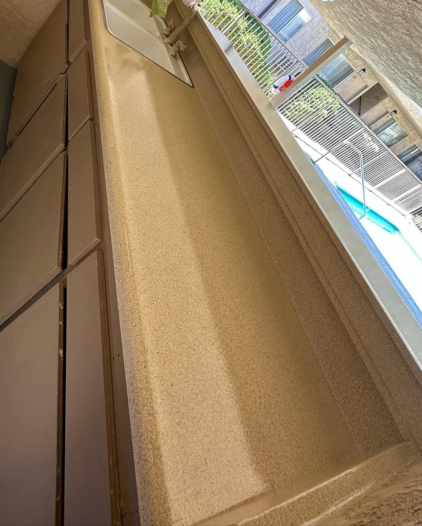 Tan cardboard box insert near a window, with a covered outdoor pool area in the background.