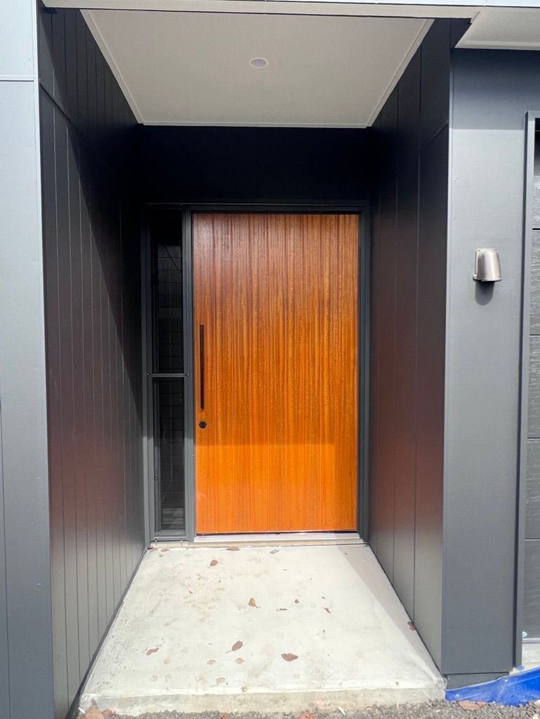 A Wooden Door in the Middle of a Hallway — Dezigner Finishes Professional Painting & Decorating in Sunshine Coast, QLD
