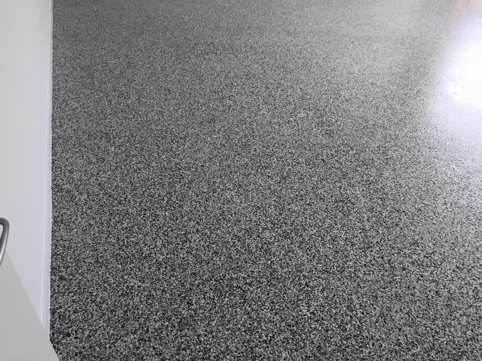 A Close Up of a Gray Carpeted Floor in a Room — Dezigner Finishes Professional Painting & Decorating in Palmview, QLD