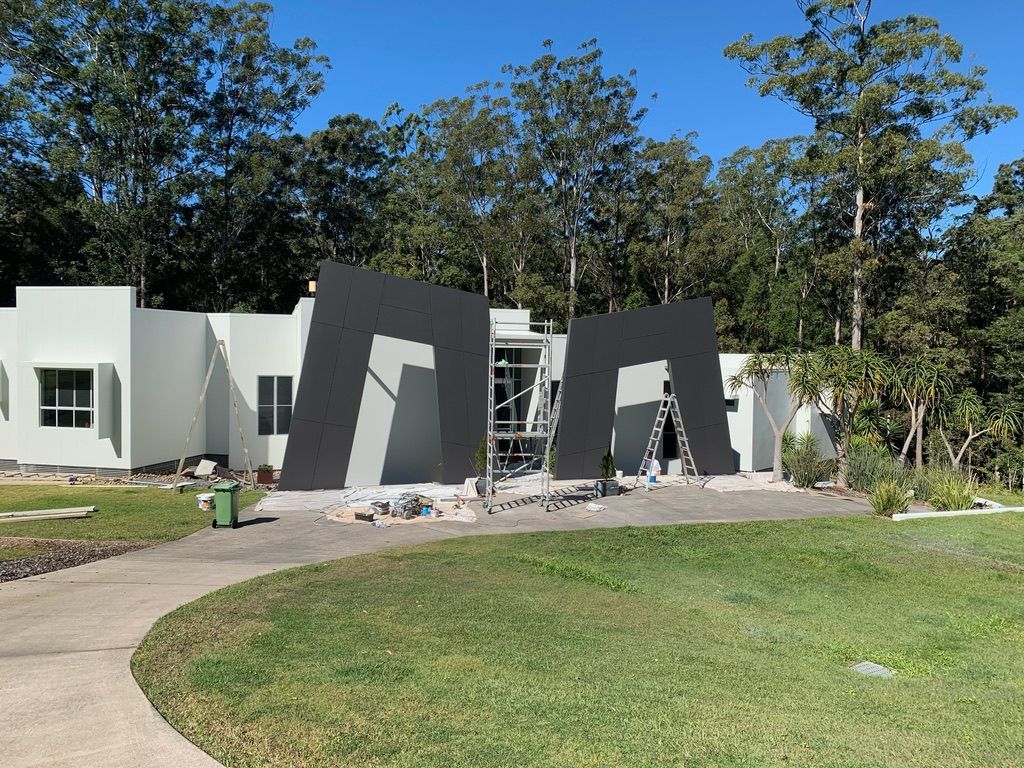 A White House With a Large Black Sculpture — Dezigner Finishes Professional Painting & Decorating in Maroochydore, QLD