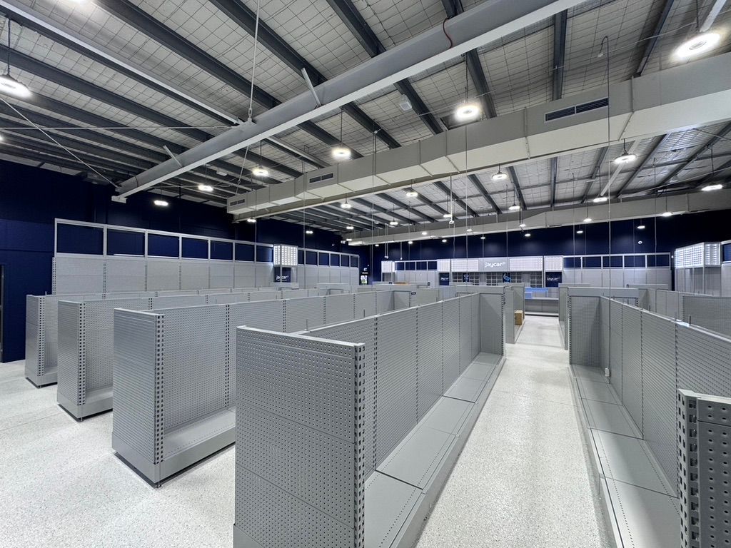 An Empty Store With Lots of Shelves — Dezigner Finishes Professional Painting & Decorating in Maroochydore, QLD