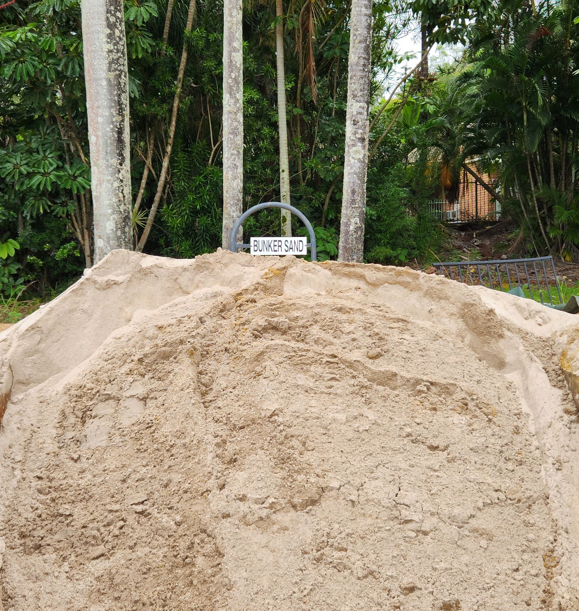 Pile of Sand With a Sign in Front of Trees — T&G Sand and Gravel In Glasshouse Mountains, QLD