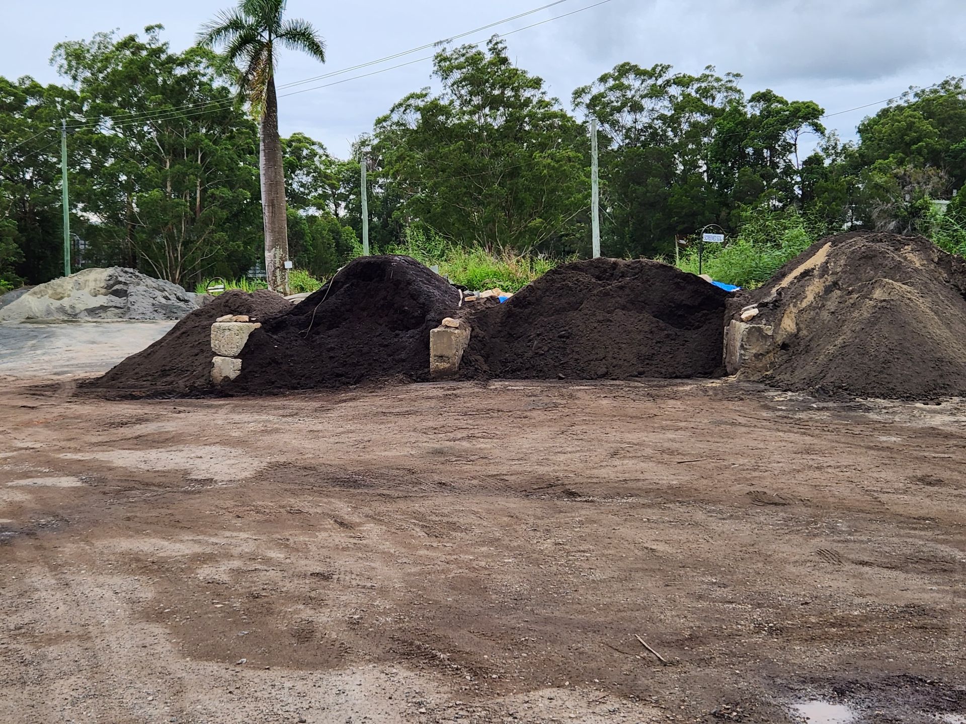 Piles of Dark Soil and Sand on a Dirt Lot — T&G Sand and Gravel In Glasshouse Mountains, QLD