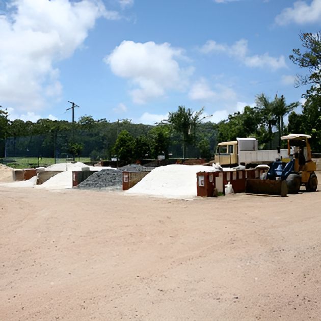 A Bulldozer Is Parked In A Dirt Area With A Truck In The Background — T&G Sand and Gravel In Sippy Downs, QLD