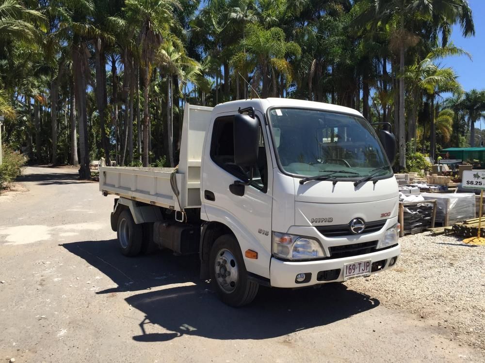 A White Dump Truck Is Parked On The Side Of The Road — T&G Sand and Gravel In Sippy Downs, QLD