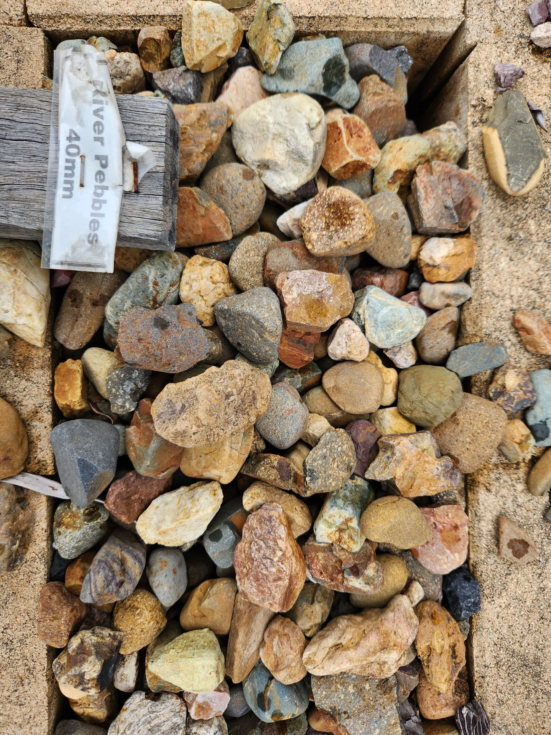Gravel Pit Filled With Assorted River Pebbles — T&G Sand and Gravel In Sippy Downs, QLD