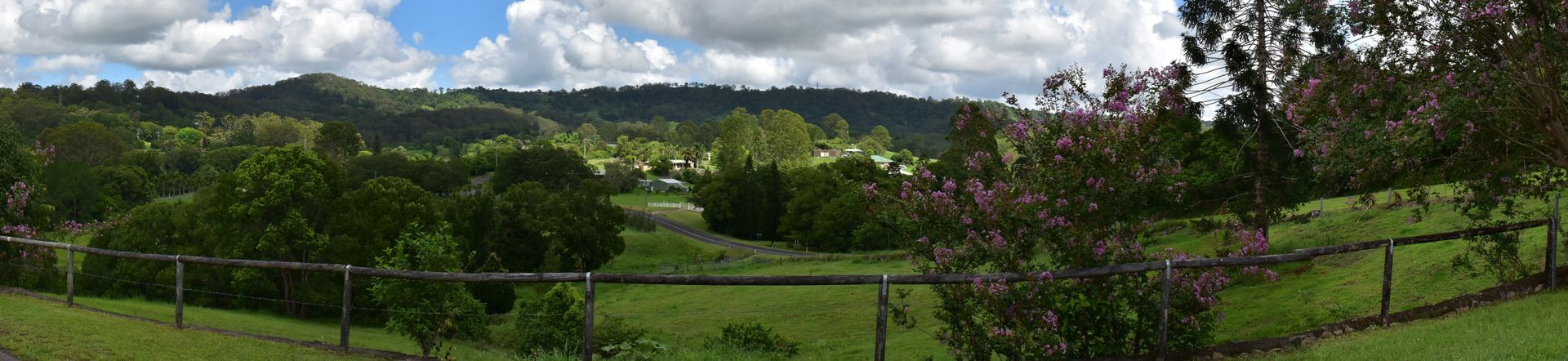 A Panoramic View Of A Lush Green Field With Trees And Mountains In The Background — T&G Sand and Gravel In Nambour, QLD