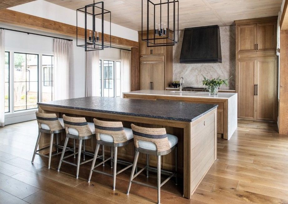Luxury kitchen with wood cabinets, two islands, and bar stools.