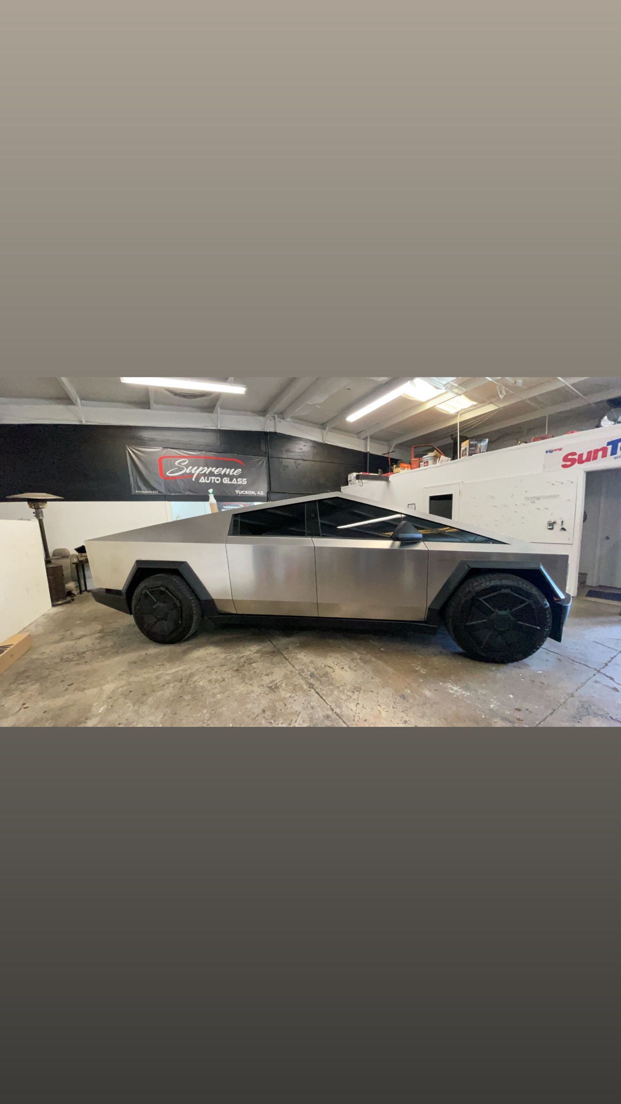 A tesla cybertruck is parked in a garage.