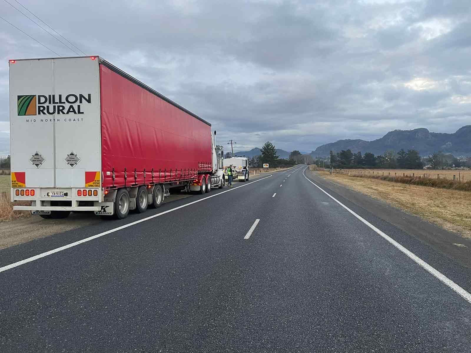 A Red And White Semi Truck Is Parked On The Side Of A Highway — Dillon Rural In Cundletown, NSW
