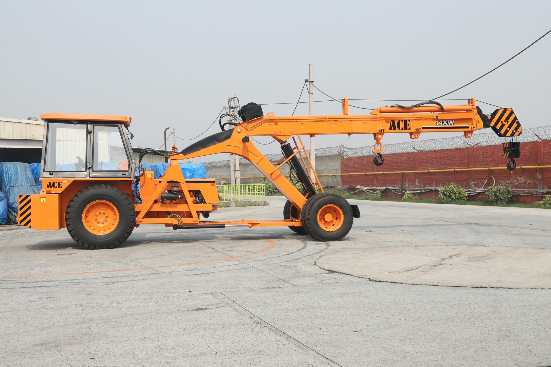 A yellow industrial pick-and-carry crane parked on a paved lot.