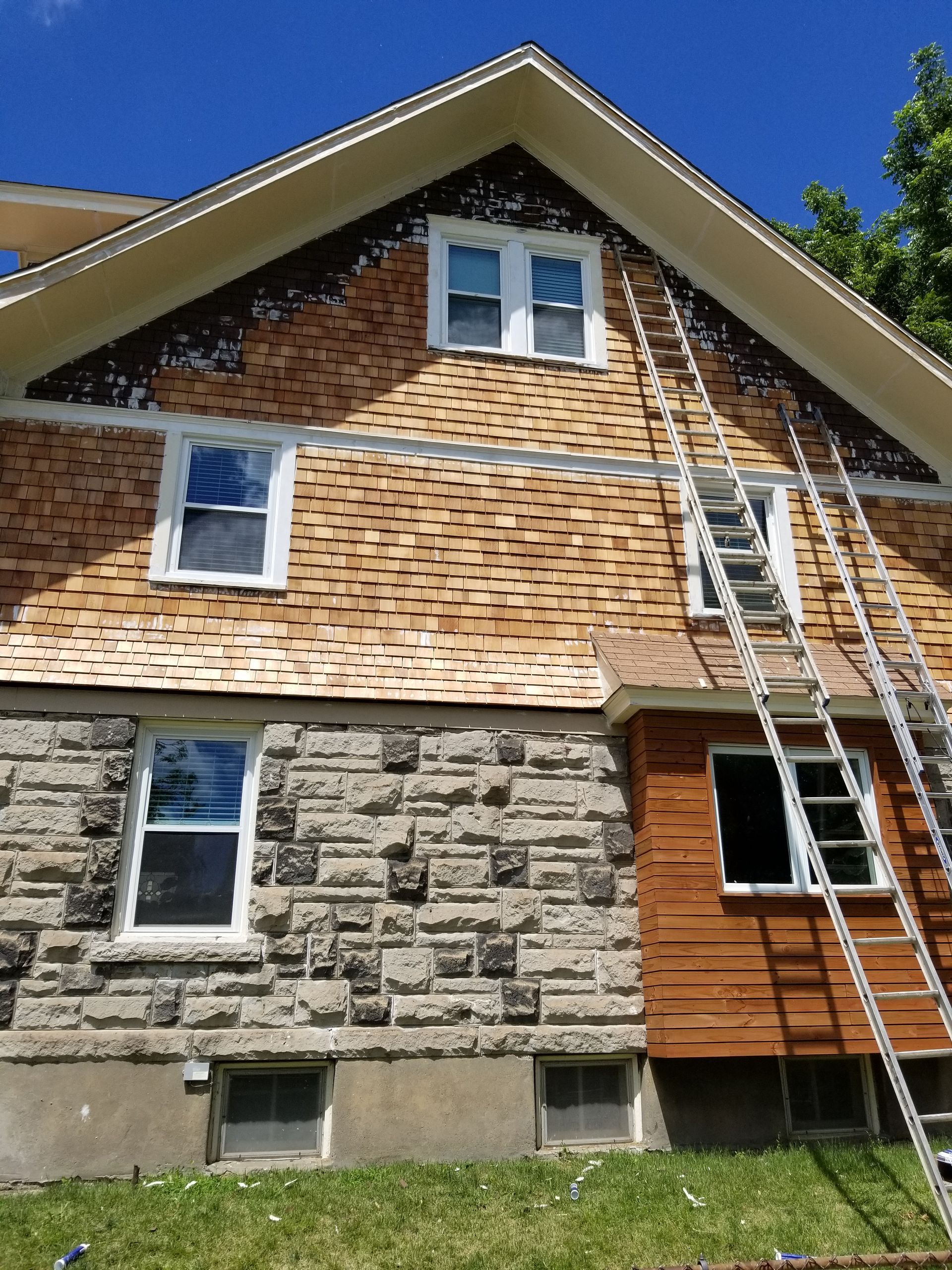 house with brand new shake shingle siding being installed