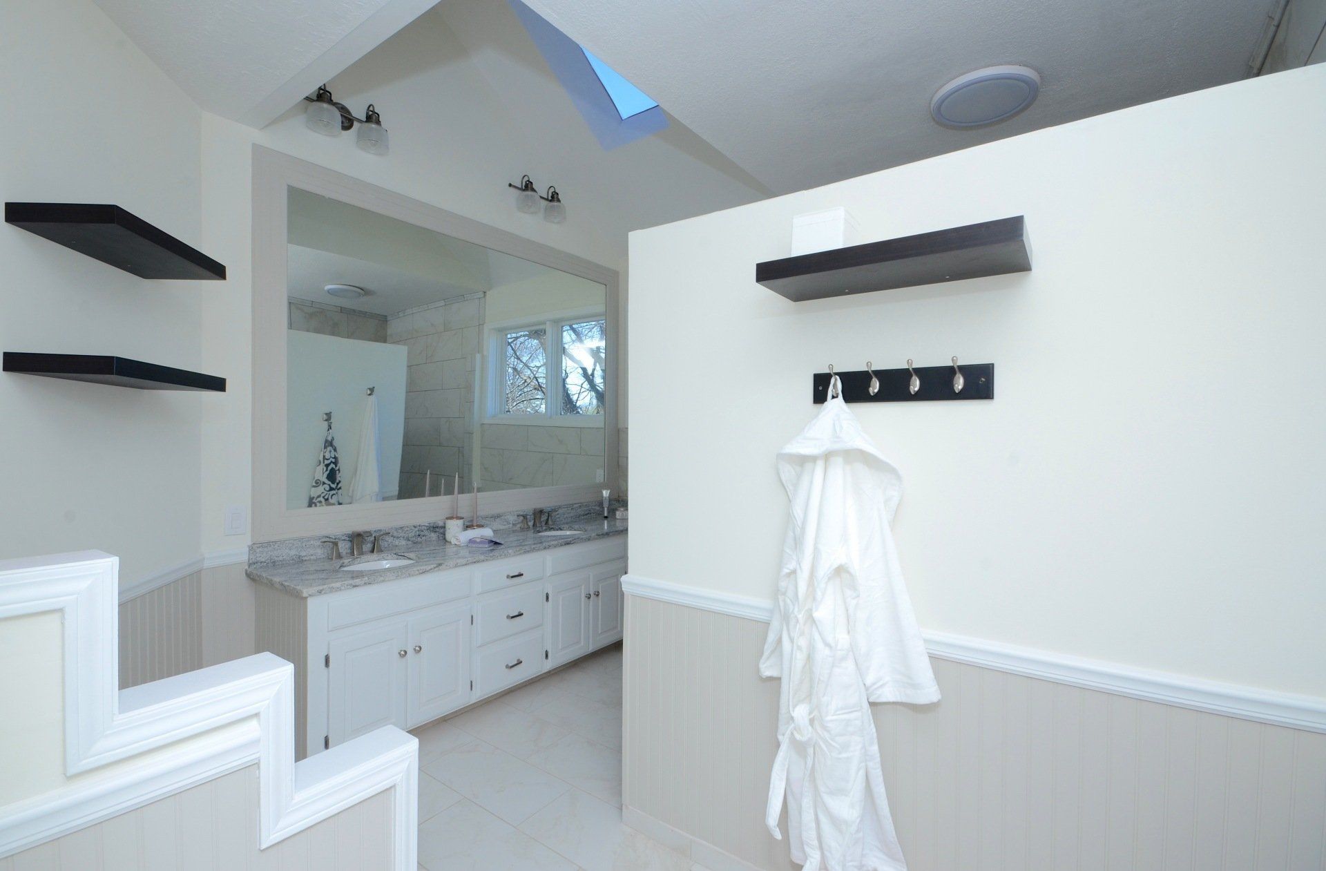 Large home bathroom, cleanly painted in white and beige