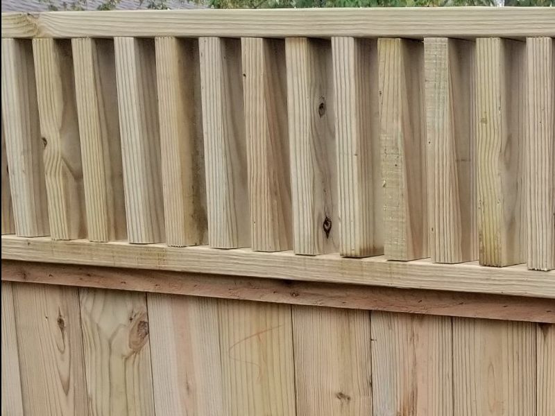 new pressure treated fence installed by home pros painting