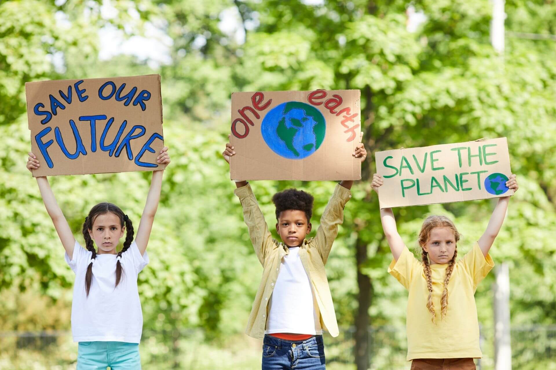 kids with picket signs to protect our planet