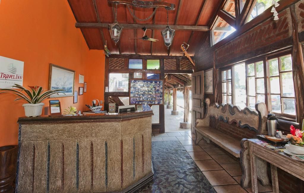 A hotel lobby with a stone counter and a wooden bench.