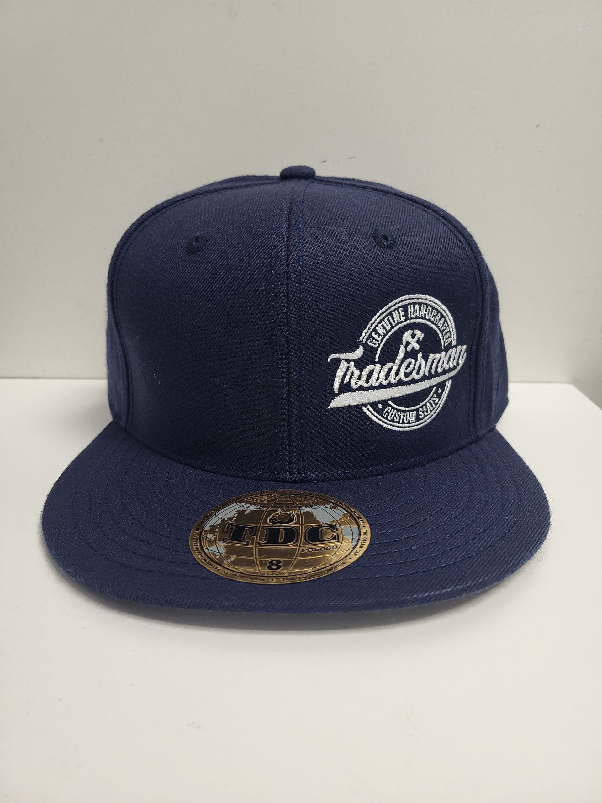 Navy blue baseball cap with a white 