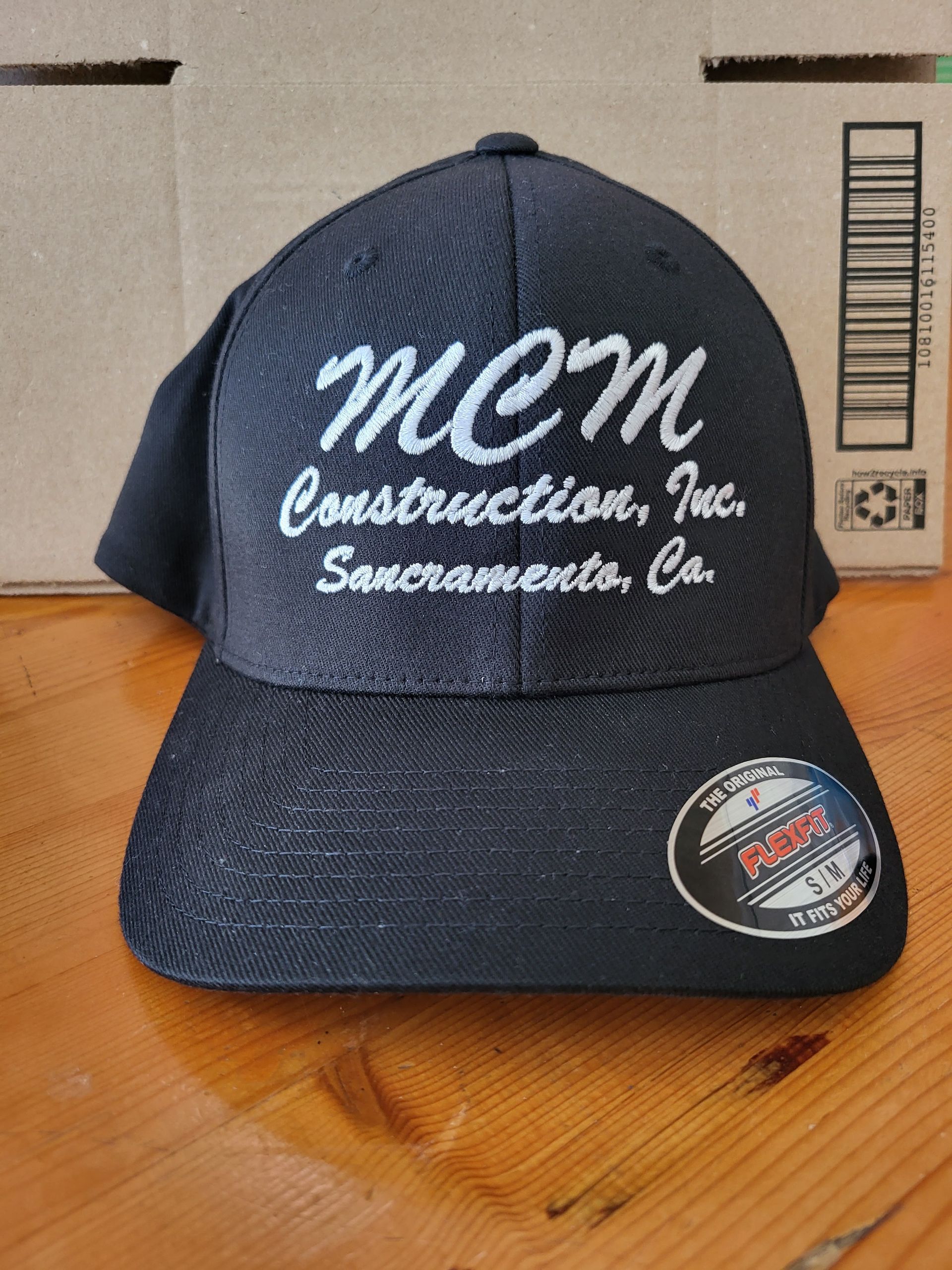 A dark blue baseball cap with white embroidered text reading 