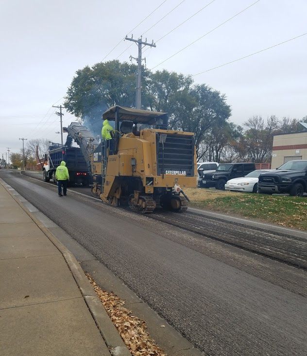 Yellow Milling Machine Removing Asphalt from Street