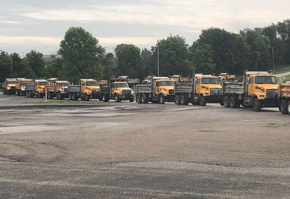 Yellow Dump Trucks Parked on Gravel Lot