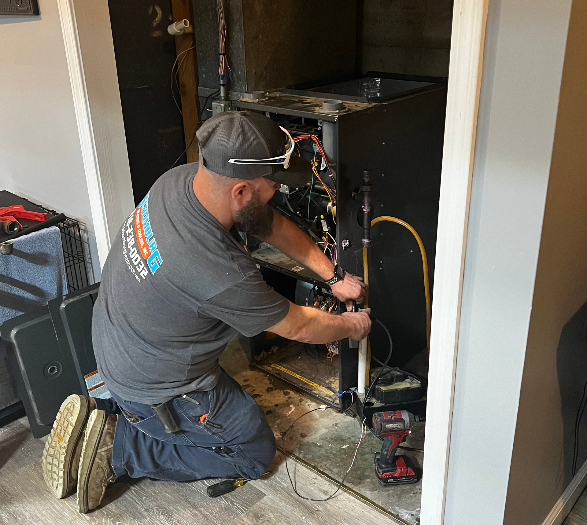 man working on furnace
