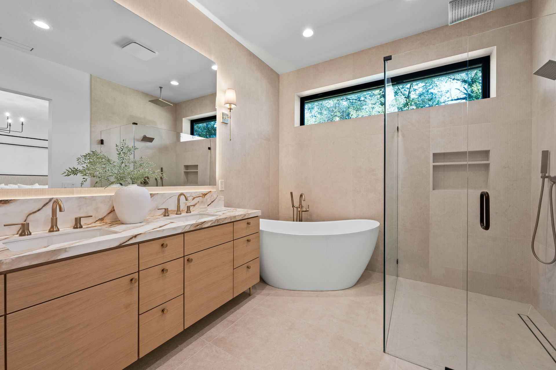 Modern bathroom with wood vanity, freestanding tub, glass shower, and narrow window