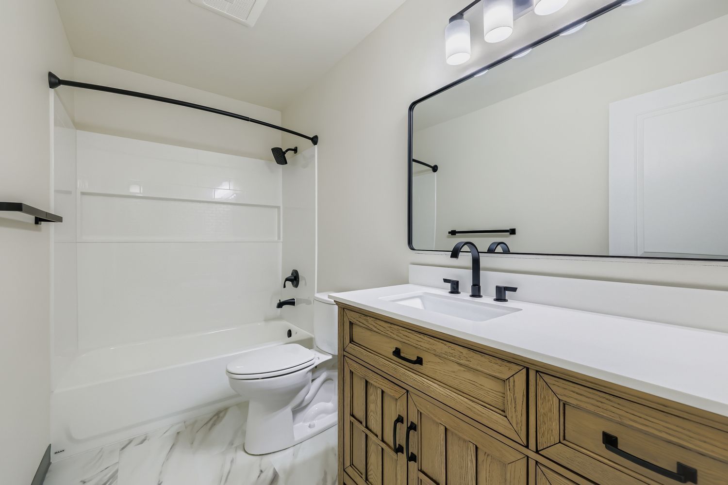 Photo of a bathroom with plenty of lighting and a wide sink