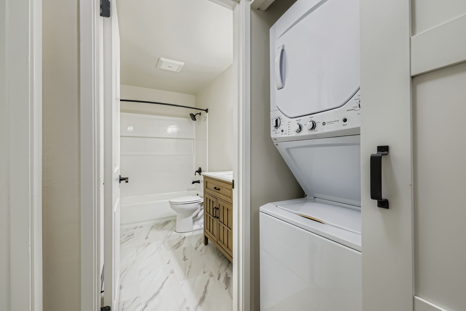 Photo of a washer/dryer area with the bathroom next to it