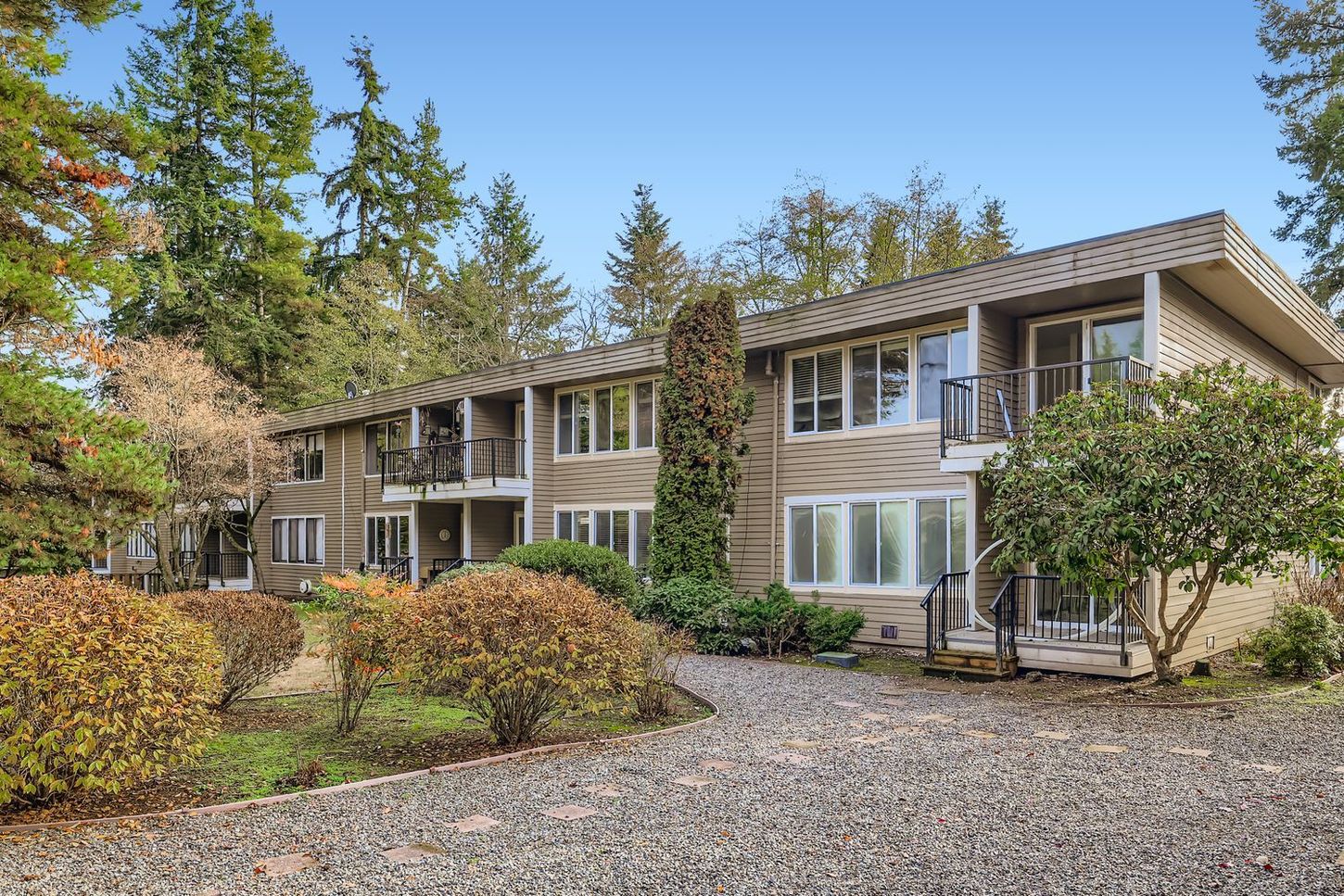 Photo of a building with a pebble-like paved path approaching, making the setting unique