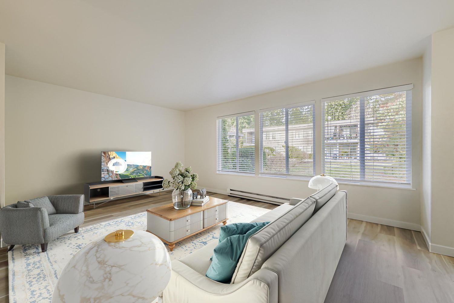 Photo of a large living room with plenty of open space and natural lighting
