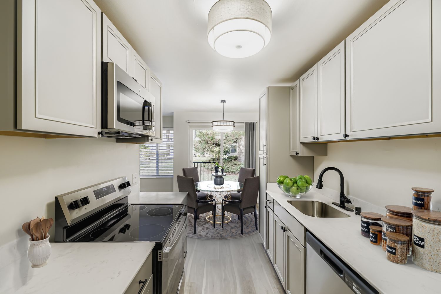 Photo of a kitchen, with the dining area in the background