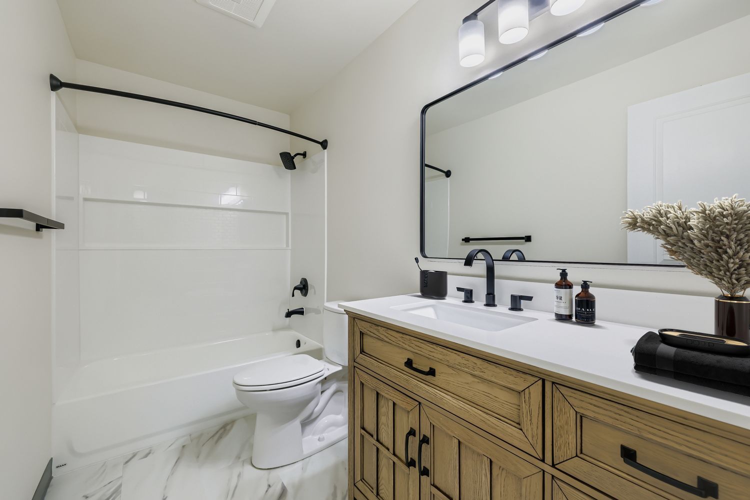 Photo of a large bathroom with a bathtub/shower combo