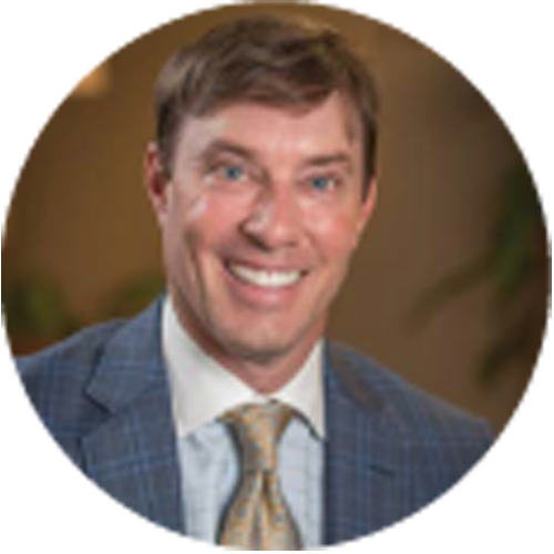 A man in a suit and tie smiles for the camera