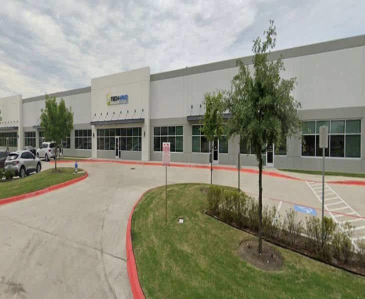 A large building with a parking lot in front of it