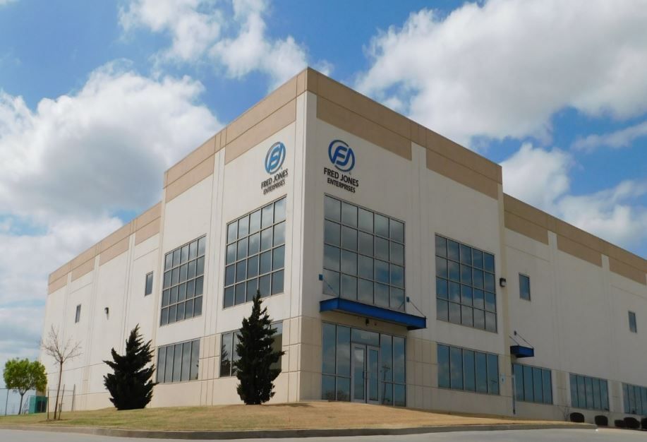 A large white building with a blue logo on the side