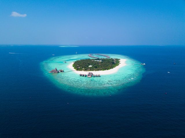 An aerial view of a small island in the middle of the ocean.