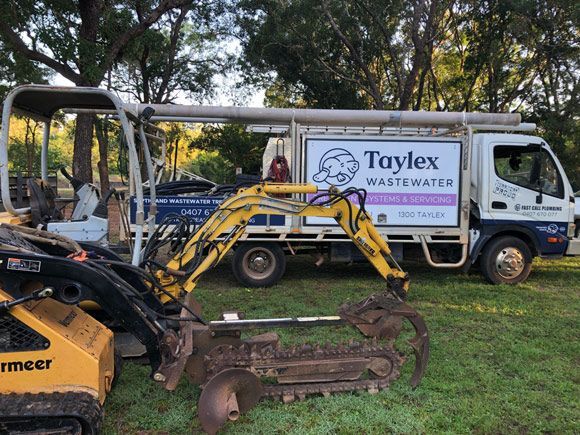 Yellow Excavator and Truck — Plumbing & Pumping in Humpty Doo