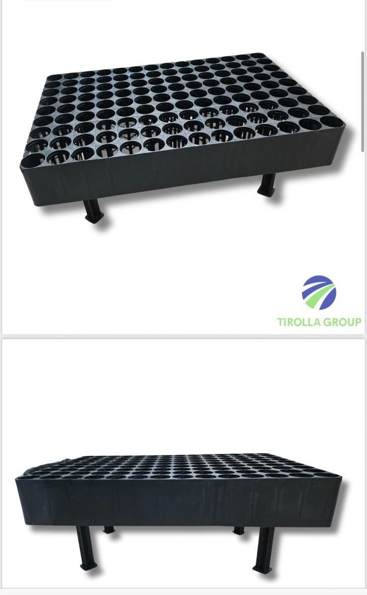 A black tray with a lot of holes in it