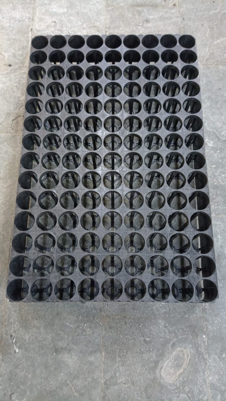 A black tray with a lot of holes in it