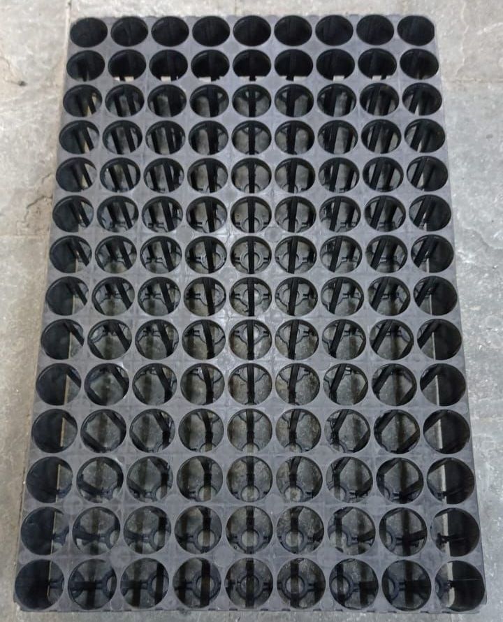 A black tray with a lot of holes in it