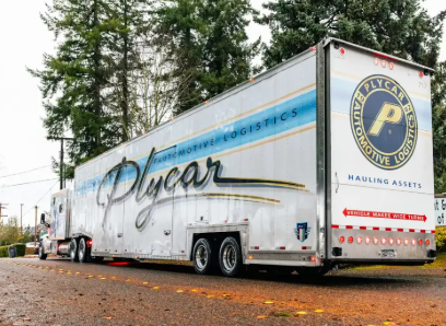 Car Repair — Eugene, OR — Vintage Underground Plycar semi-truck parked outdoors. White trailer with blue stripes and logo.
