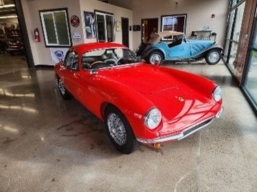 A bright red classic car parked indoors. A bright red classic car parked indoors.